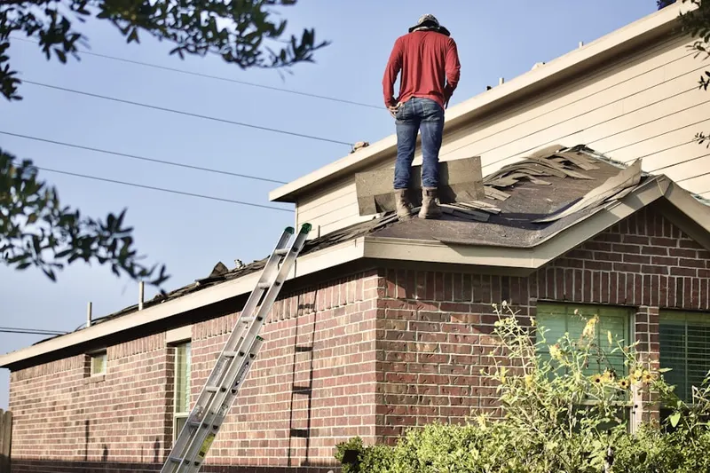 Professional roofer working on a residential roof in Harlingen